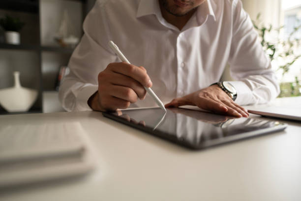 istock Young businessman using digital tablet while working in business office. 2131001088