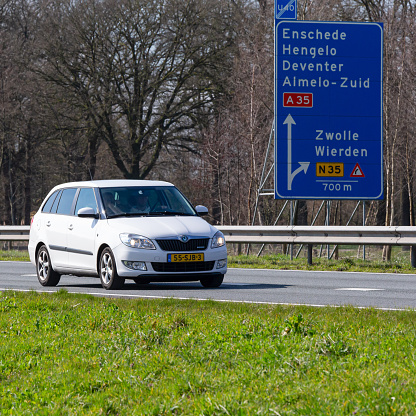 Netherlands, Overijssel, Twente, Wierden, March 19th 2023, side/front view close-up of a Dutch white 2011 Skoda 2nd generation Fabia station wagon diesel driving on the N36 at Wierden, the Fabia is made by Czech car manufacturer Škoda Auto since 1999, the N36 is a 36 kilometer long highway from Wierden to Ommen