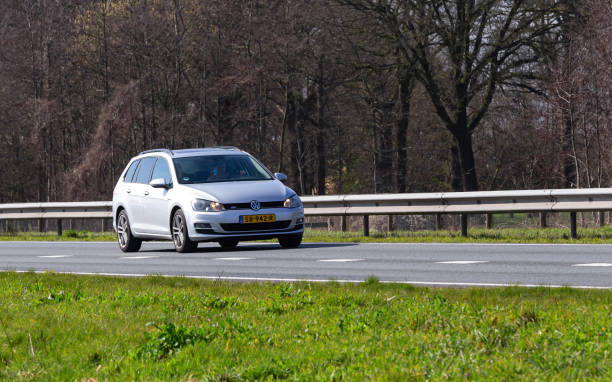Netherlands, Overijssel, Twente, Wierden, March 19th 2023, side/front view close-up of a Dutch  gray 2014 Volkswagen 7th generation Golf station wagon diesel driving on the N36 at Wierden, the Golf has been made by German manufacturer Volkswagen since 1974, the N36 is a 36 kilometer long highway from Wierden to Ommen