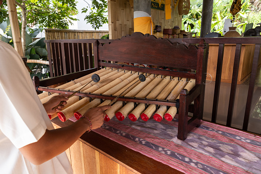 Male hands playing the national Indonesian wind instrument, Indonesia