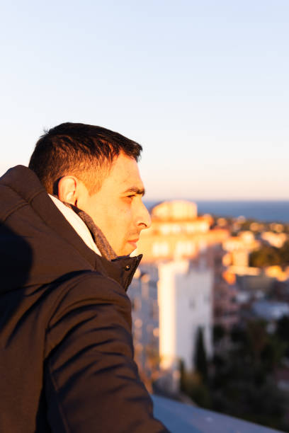 istock Man contemplating the view from the balcony 2131011647