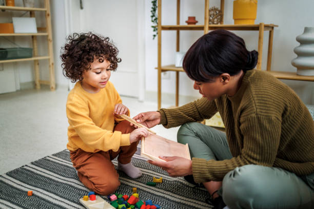 istock Mother and cute little boy playing at home 2131026906