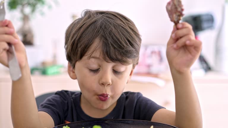 Joyful Dance And Satisfaction From Flavor Explosion As Little Boy Bites Steak And Grabs Cassava Piece