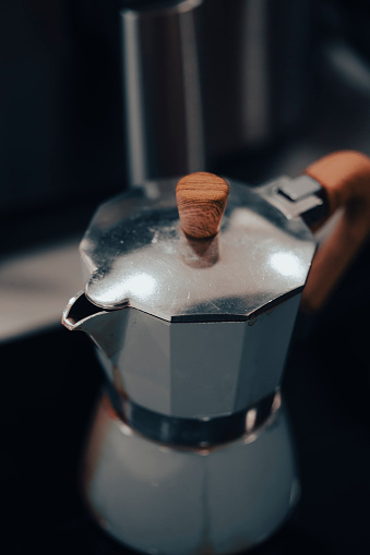 Old inox domestic espresso coffee machine in a kitchen Close up still