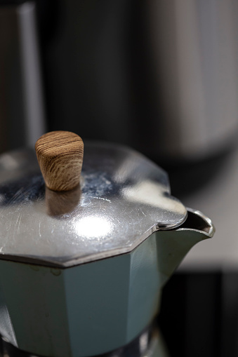 Old inox domestic espresso coffee machine in a kitchen Close up still