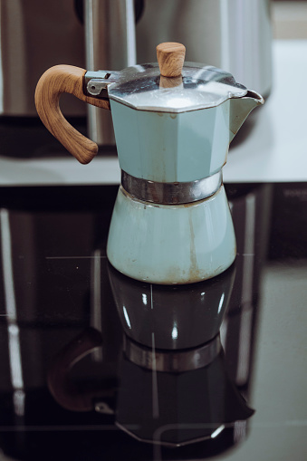 Old inox domestic espresso coffee machine in a kitchen Close up still