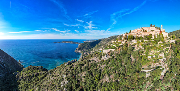 Sunrise aerial flyover above the beautiful French Village of Eze on the Mediterranean Sea - French Riviera