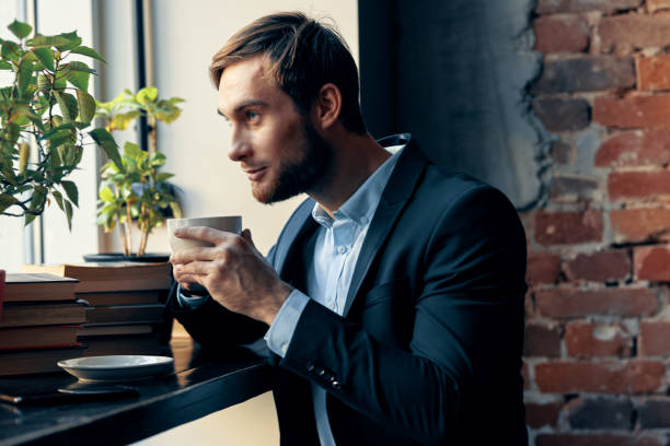 istock business man in a cafe suit drinking cafe rest breakfast 2131104658
