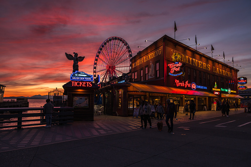 Seattle, USA – Mar 31, 2024: Sunset over Miners Landing on the Waterfront.