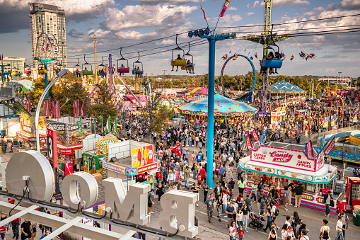 Toronto, Canada - August 31, 2022:  Crowds walk along the amusement rides and games The Canadian National Exhibition (CNE), also known as The Ex, is an annual event that takes place at Exhibition Place in Toronto, Ontario, Canada