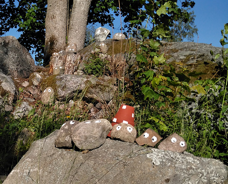 Painted troll stones populating the forest in Tiveden natural reserve