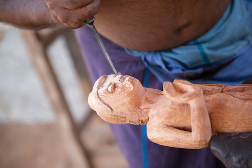 Kolutara, Sri Lanka 09 february 2023. Sri Lankan Traditional wood craft and craftsmen. small private workshop-shop for making handmade souvenirs from wood. master carves a Buddha figurine