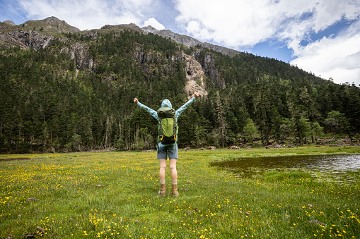 Hiking woman in high altitude grassland