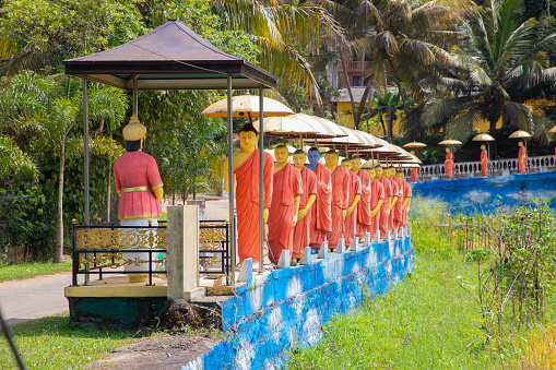 Dambulla, Sri Lanka 10 february 2023. row of Buddhist monk statues adjacent to Golden Temple at Dambulla central Sri Lanka.