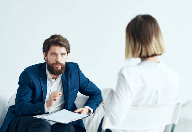 istock A man is a psychologist with documents and a woman at a doctor's appointment 2131163117