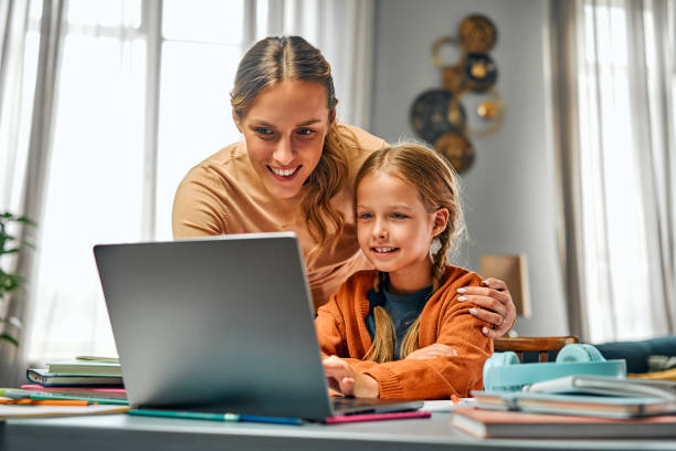 istock Online training for children. Parent looking at child setting application for connecting to distant lesson 2131171988