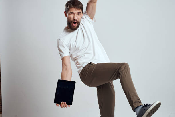 istock emotional man with tablet in hand touch screen new technologies light background cropped view Copy Space 2131189833