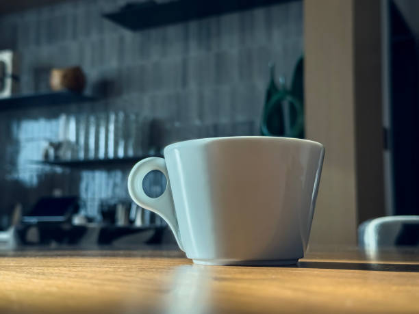 istock White cup of coffee on the table. 2131201797