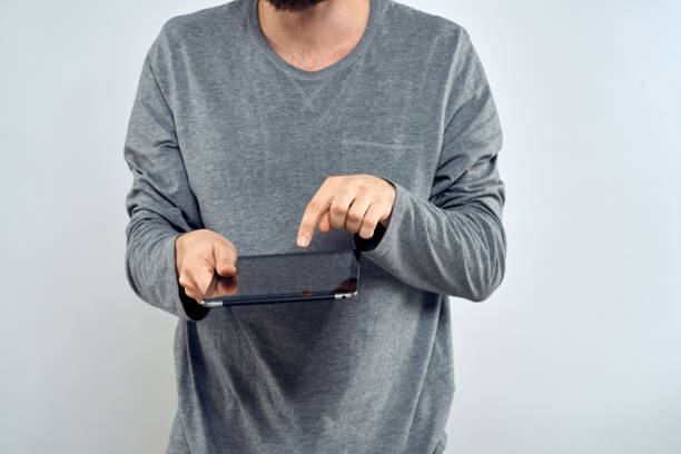Man with tablet in hands technology internet lifestyle confident cropped view. High quality photo