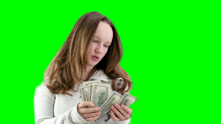 young woman with a calm face counts out 100 dollar bills on a white background beautiful well-groomed hair money for beauty beauty salon buy pay old and new banknotes