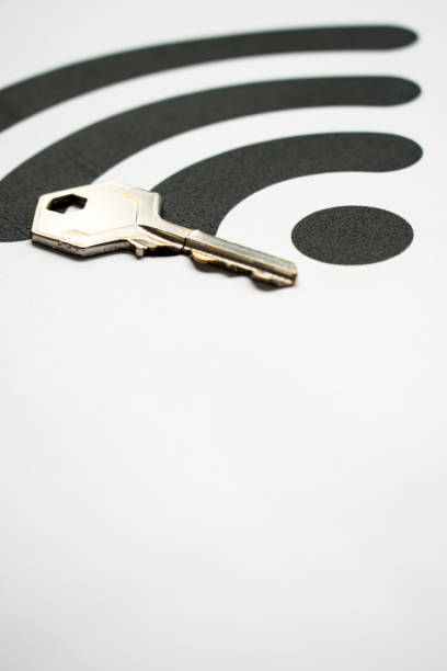 Metal key on a white background with a big black Wifi symbol and copy space