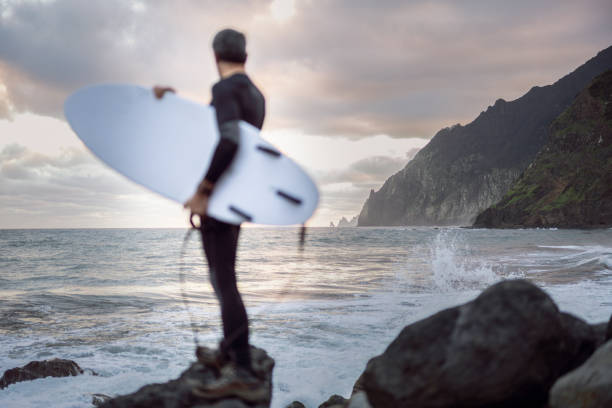 istock Surfing at sunrise. It's time to ride the waves. 2131375674