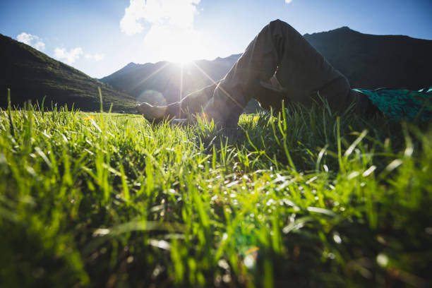 Woman hiker relax on beautiful sunset grassland