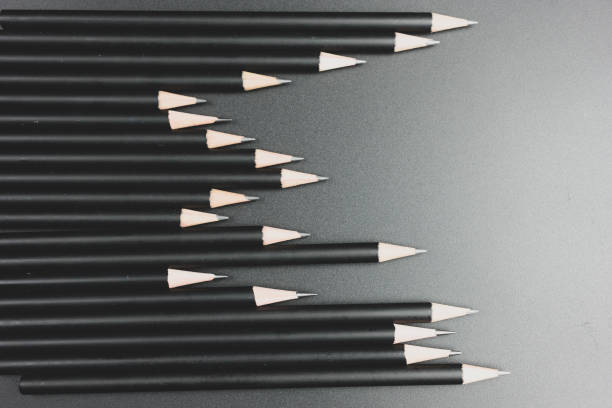 Black pencils on the matte black background. Minimal style. Conceptual minimalist black art.