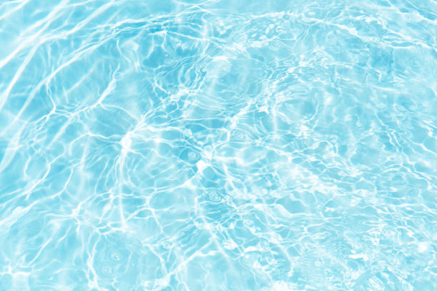 istock Blue water surface texture with ripples, splashes, and bubbles. Abstract summer banner background Water waves in sunlight with copy space cosmetic moisturizer micellar toner emulsion. Blue water wave. 2131634590