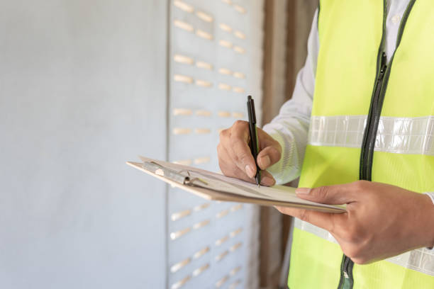 istock inspector or engineer is inspecting construction and quality assurance new house using a checklist. Engineers or architects or contactor work to build the house before handing it over to the homeowner 2131650951