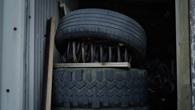 Handheld tires piled up in doorway with steel coil
