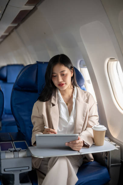 istock A hard-working businesswoman focus on her work on her tablet while flying for a business meeting. 2131755809