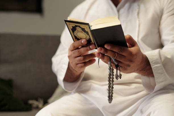 istock Unrecognizable Muslim Reading Quran Surah 2131762996