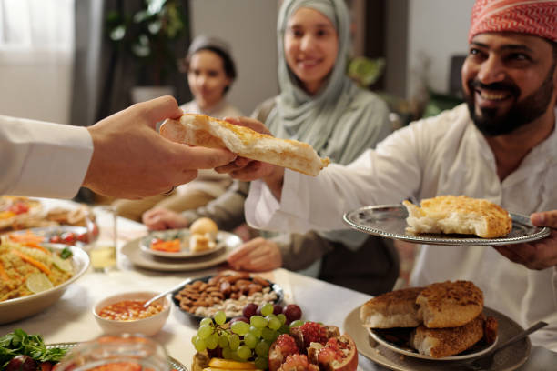 istock Muslim Family Sharing Flatbread At Festive Dinner 2131766057