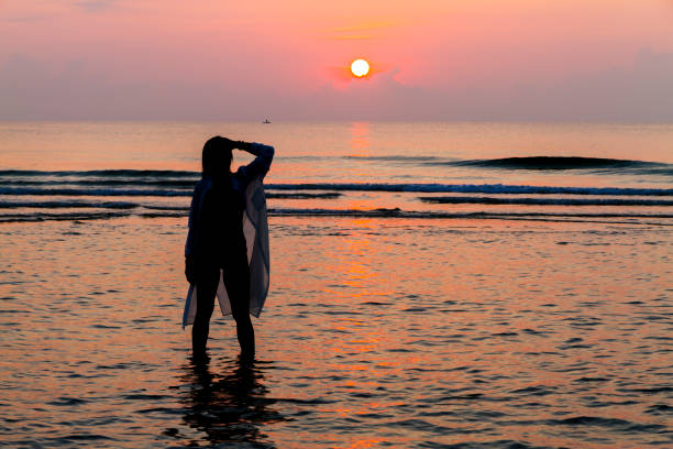istock Woman pretty with bikini and silhouette on beach 2131767586