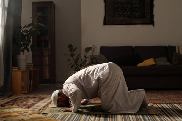 istock Mature Man Doing Namaz In Living Room 2131793018