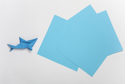 Blue paper shark on white background