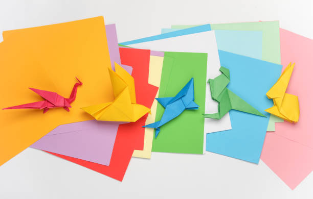 istock Paper folded origami animal figurines on a white background. Hobbies, creativity 2131795197