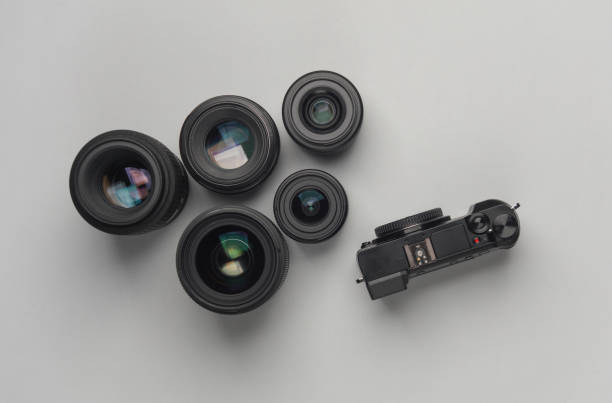 istock Modern digital mirrorless camera with lenses on gray background. Equipment for professional photographer. Top view 2131795351