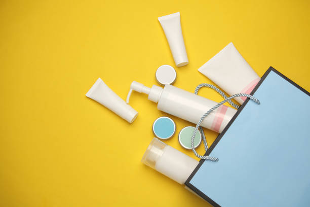 istock Blue cardboard bag with cosmetics on a yellow background 2131798071