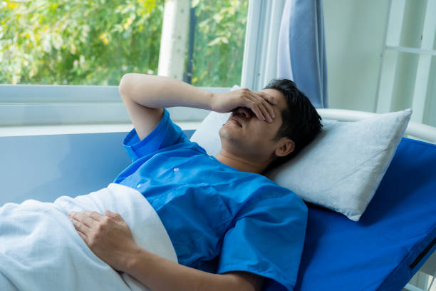 istock A young Asian patient had a headache in a hospital bed while wearing a blue uniform while being admitted to the hospital. 2131807990