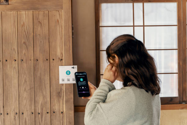 istock Mid adult woman using a multilingual audio guide smartphone app while visiting a Japanese shrine 2131853085