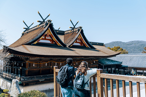 Two tourists visiting a Japanese shrine in Okayama Prefecture while on vacation