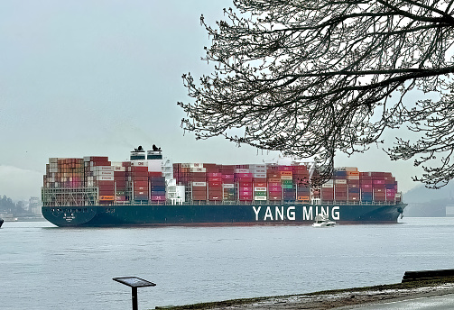 Vancouver, British Columbia, Canada. Mar 27, 2024. A large-scale export and import container vessel approaching the coastline of Vancouver. Massive container ship boat.