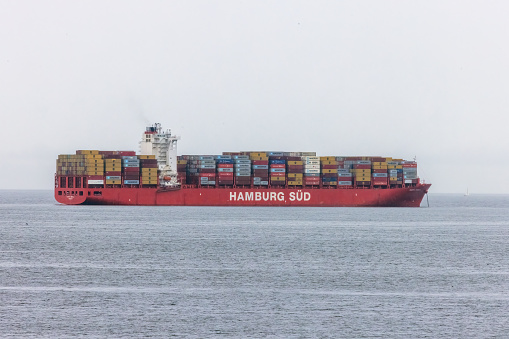 Vancouver, British Columbia, Canada. Mar 24, 2024. A large-scale export and import container vessel approaching the coastline of Vancouver. Massive container ship boat.