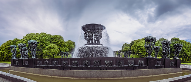 Panoramic view of fountain in Vigeland Sculpture Park in Oslo, Norway, on overcast day
