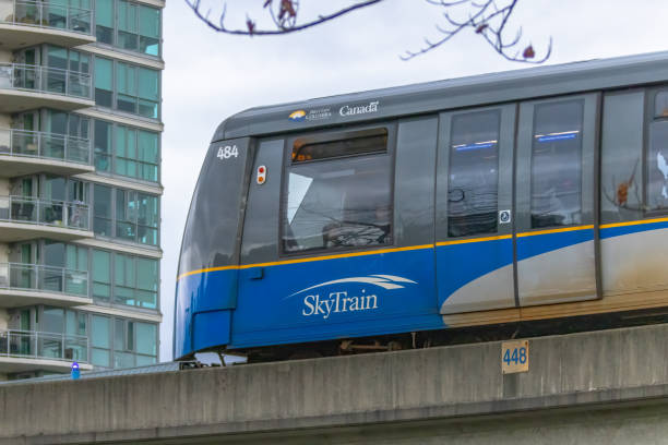 Passenger's view from front seat of a fully automated self-driving light rapid transit train in motion.  Similar oncoming train on the left track.  Vancouver, British Columbia, Canada.
