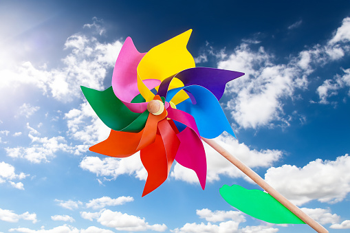 Close-up image of beautiful colorful paper windmills used for home decoration.