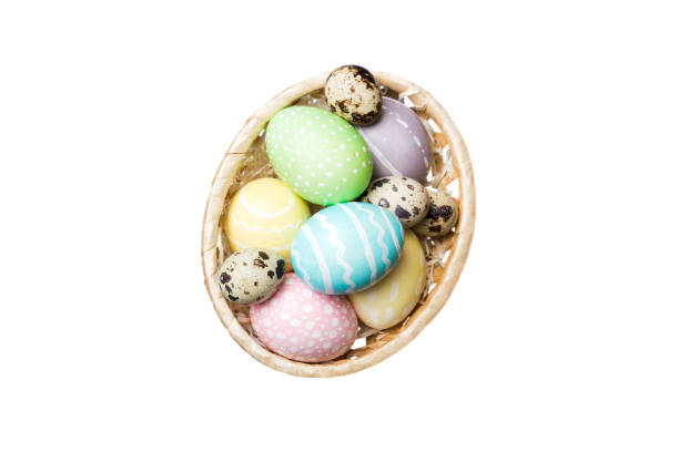 istock Basket of colorful Easter eggs isolated on white background. Easter basket filled with colored eggs top view holiday concept 2131929489