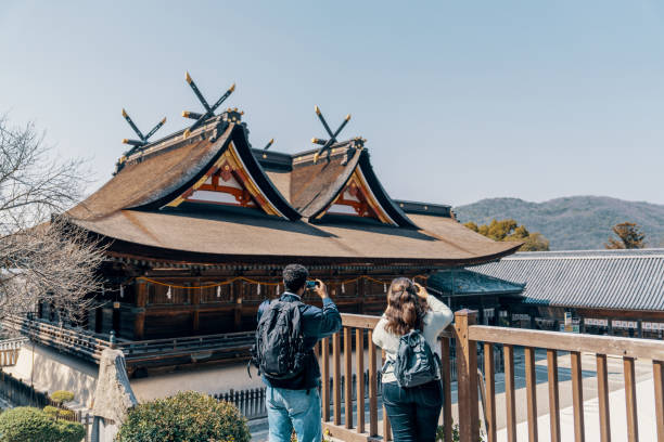 istock Two tourists taking pictures with smartphones while visiting a shrine in Japan while on vacation 2131950143